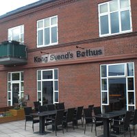 outside of the restaurant with large terrace outside and entry portal