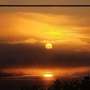 Above Tide Motel in Vancouver Island, image may contain: Balcony, Bed, Chair, Monitor