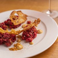 Battuta al coltello condita con capperi, cipolla rossa, peperoni, cetriolini e salsa Tartara
