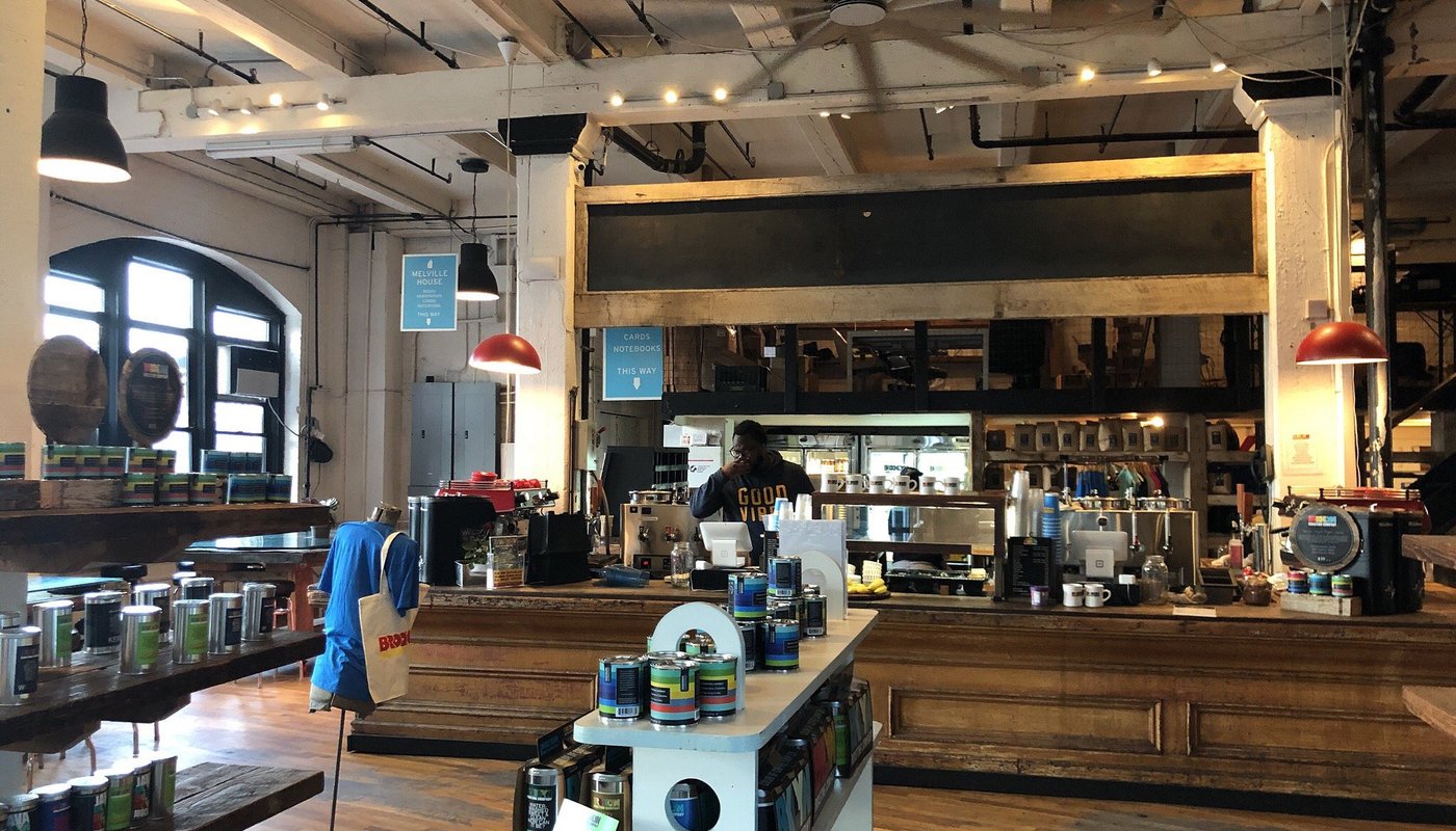 Interior of Brooklyn Roasting Company café in DUMBO with roastery equipment and seating