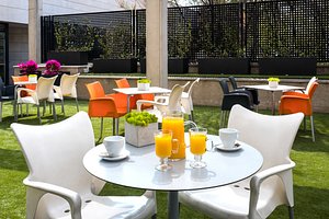 Hotel Tach Madrid Airport in Madrid, image may contain: Table, Dining Table, Grass, Backyard