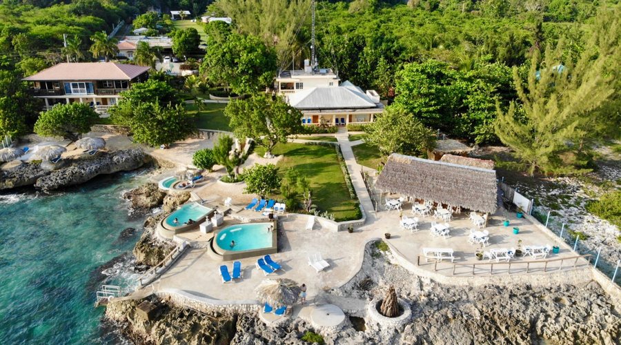 Westender Inn Oceanside Rooms + Suites, sundeck, pools, restaurant and bar.  Garden Cottages can be seen in the top of the photo. 