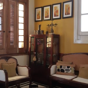 Cozy relaxing area at the entrance to the kitchen.  Full of art and antiques.