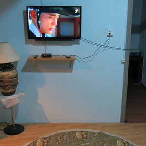 Living room with Sofa & TV  channel. Refrigerator & Washing machine for guests to use.
