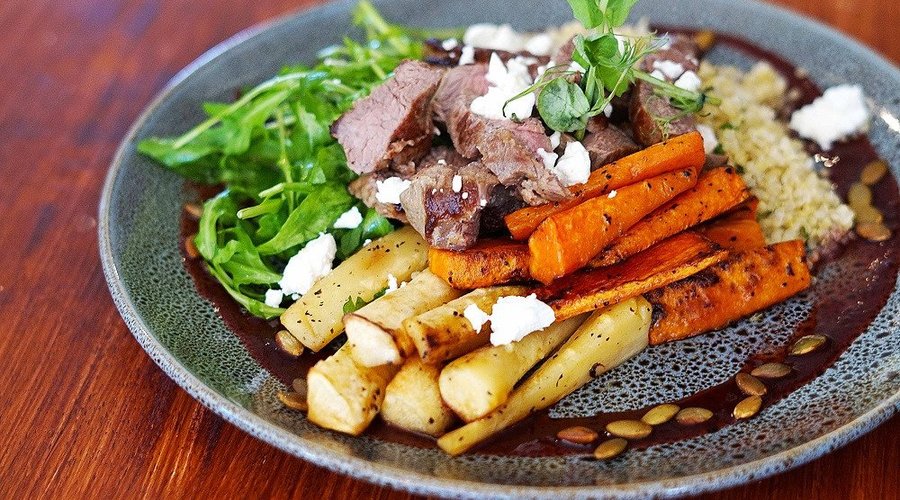 Warm Lamb Salad. Seared lamb rump, roast winter vegetables, minted quinoa, spiced roasted pumpkin seeds, rocket, drizzled with our Lava balsamic plum sauce and finished with crumbled goats cheese.