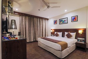 Hotel Blue Stone - Nehru Place in New Delhi, image may contain: Corner, Interior Design, Ceiling Fan, Table Lamp