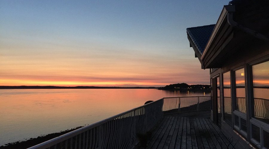Peaceful sunset view of Masset Inlet and Old Masset from the patio of White Raven House.
