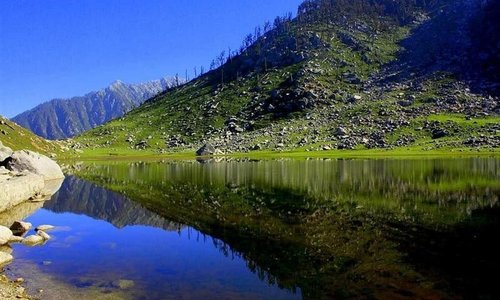 Clear weather; A place with Picturesque view. peaceful valley of snow with white water lake;
