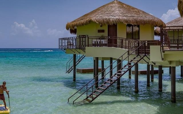 This is an outside view of a Palafito which is positioned directly in the ocean