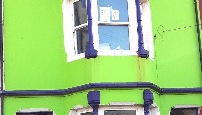 The cheerful bright green front of the Bijou Borth Bunkhouse