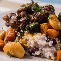 Oxtail made with carrots and butter beans, served with rice and beans.