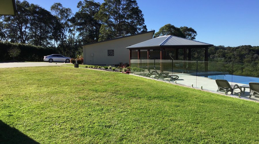 View of the pool, BBQ area and rooms in the distance