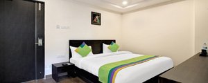 Treebo Trend Excella in Visakhapatnam, image may contain: Bed, Furniture, Interior Design, Corner