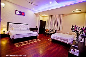 Hotel Krishnam Vrindavan in Vrindavan, image may contain: Flooring, Interior Design, Remote Control, Bed