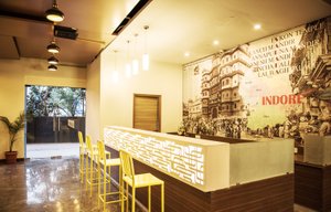 Cosmopolitan Hotel Indore in Indore, image may contain: Restaurant, Interior Design, Table, Chair