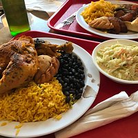 Beans and yellow rice, beef stew, roasted chicken, empanadas, plantains and a side of coleslaw.