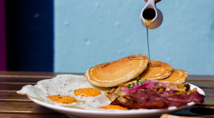 Grand Slam - 3 eggs, 3 bacon, hash, roast tomato, 2 pancakes, toast, fruit bowl    
add cheese on hash : 20k