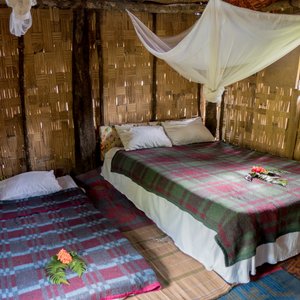 With bamboo walls and thatched roofs and nice comfy beds with all beddings.