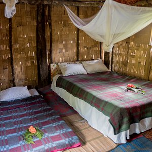 With bamboo walls and thatched roofs and nice comfy beds with all beddings.