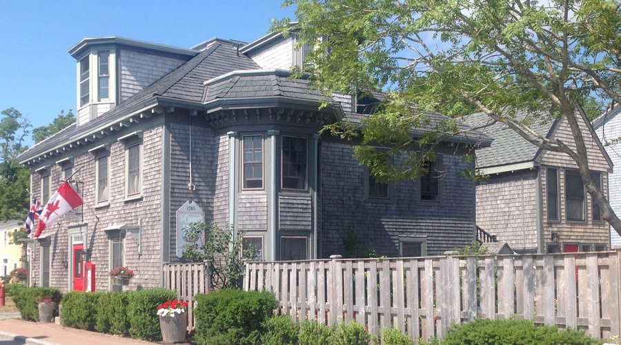 The Cooper's Inn has graced Dock Street since c1784. This view features the Inn, the Annex and fenced Garden area.Privacy on the waterfront with Shelburne Harbour views, private entries, ensuite baths and more.