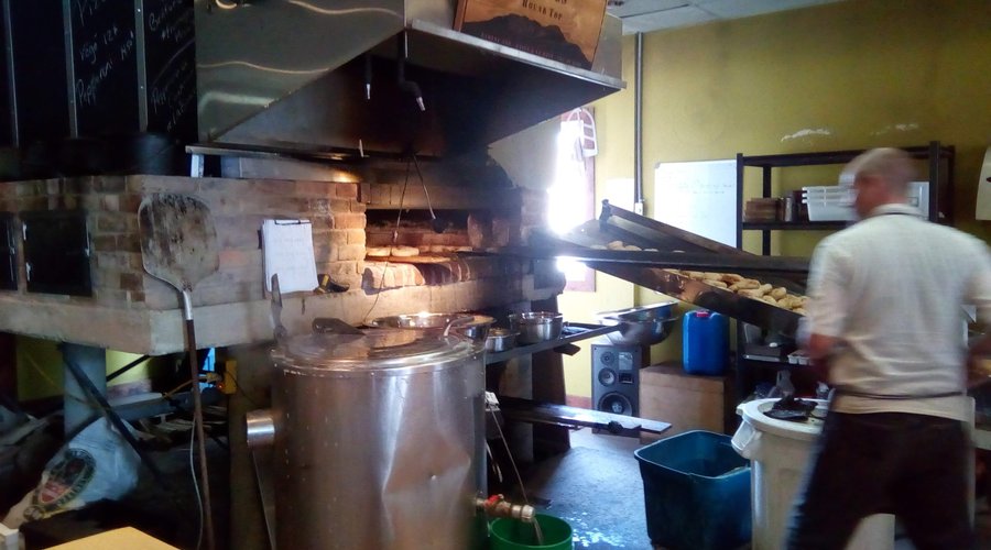 Loading the bagels into the wood'fired oven