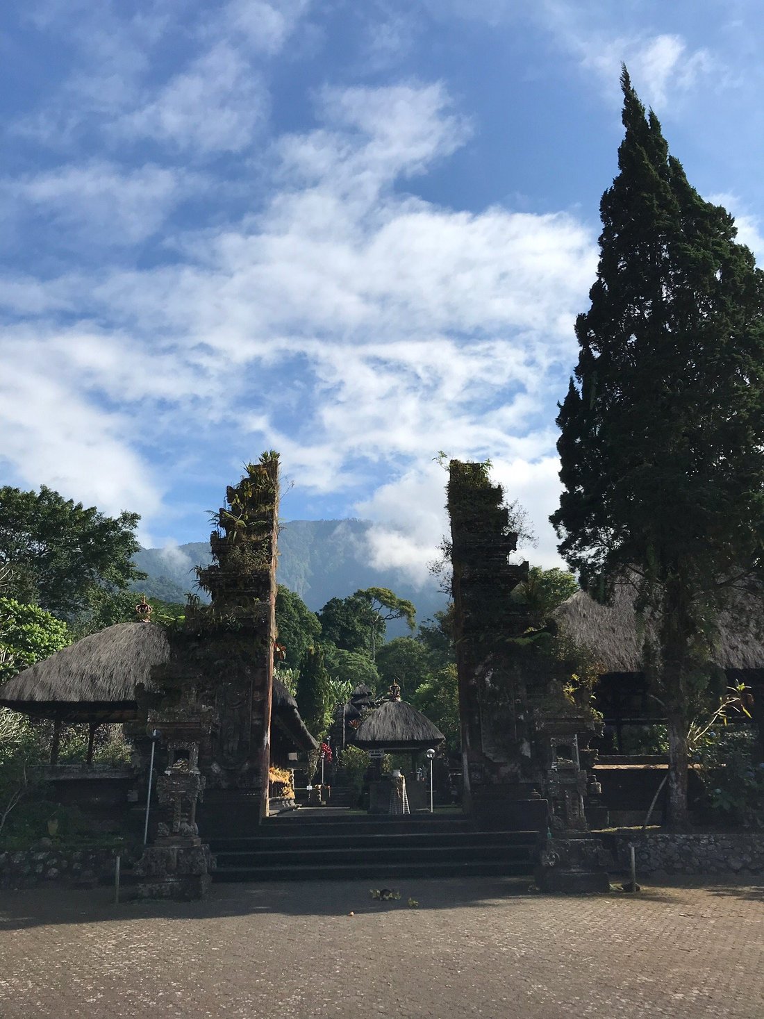 Ancient temple with 7-tiered meru tower surrounded by lush forest