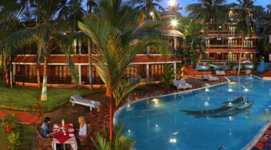 A large expanse of water, the pool is set softly amidst lush greenery reminiscent of some place.