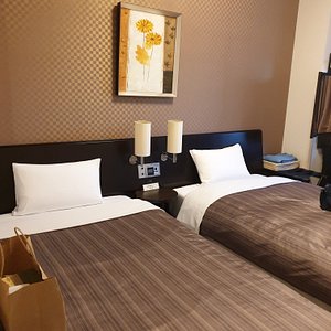 Hotel Route Inn Sapporo Ekimae Kitaguchi in Sapporo, image may contain: Handbag, Furniture, Interior Design, Dorm Room