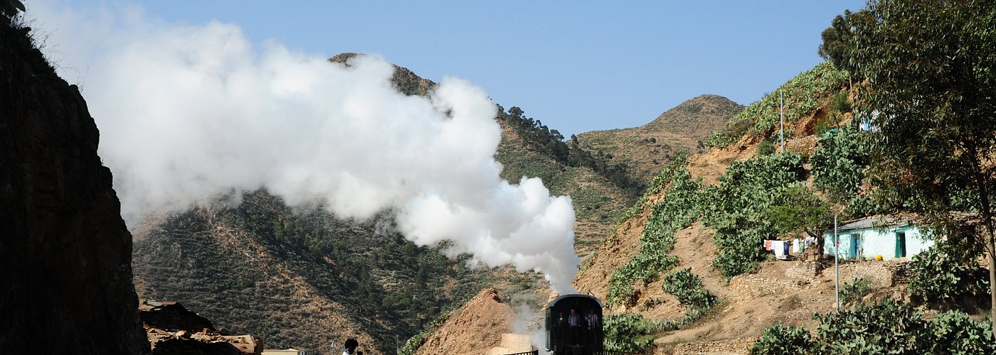 A riveting 19-century steam train excursion trip through the mountains from Asmara downhill to Nefasit and uphill back to Asmara with Africa’s oldest yet recently renovated railway.
 The spectacular ride on one of the oldest steam locomotives in existence in Africa, huffing and puffing along steep canyons, deep valleys and through dark tunnels is utterly thrilling. Traveling in one of these old-timers is as if you were in a big cinema hall with a wide screen in front of you.