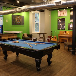 Lounge with free billiards table, piano and guitars.