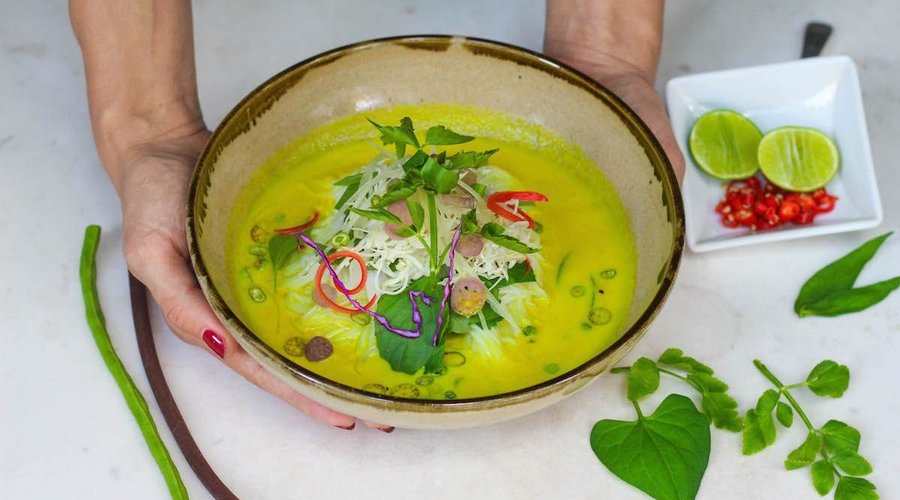 A beautifully plated bowl of Nom Banh Chok, showcasing fresh rice noodles