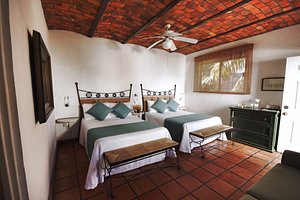 Los Milagros Hotel in Cabo San Lucas, image may contain: Resort, Ceiling Fan, Bed, Furniture