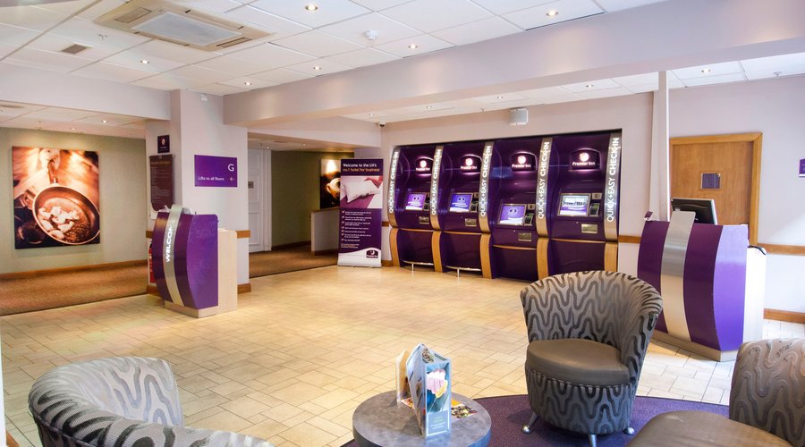 Premier Inn reception with check in desk and kiosks