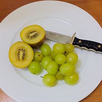 Yellow kiwi fruit and green grapes