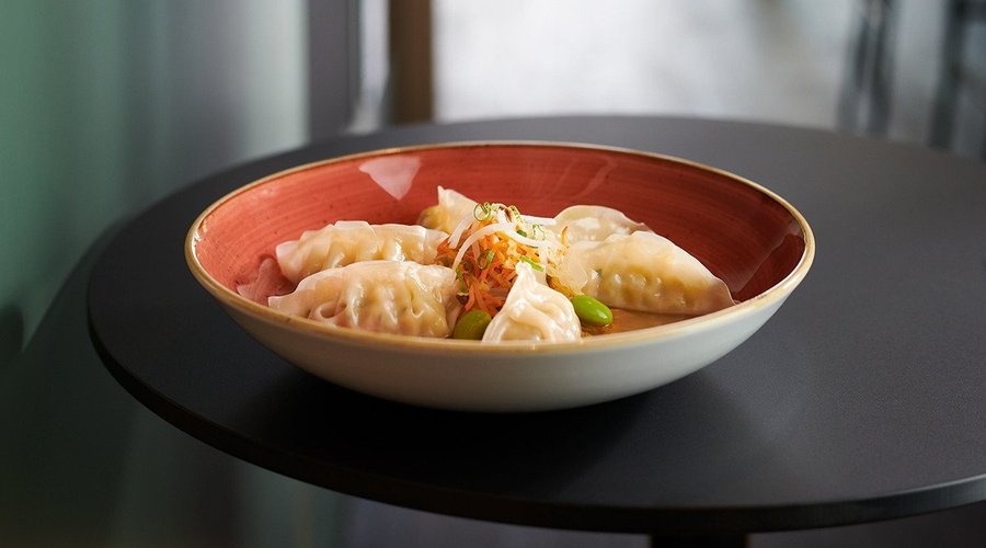 Steamed vegetable Gyoza in cold Miso soup with asian vegetables and Edamame