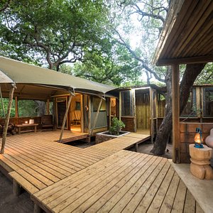 This is a spacious luxury safari tent with an off set bathroom, outside shower, a bath, his and her amenities, spacious deck overlooking the bushveld and a private pergola with a day bed.