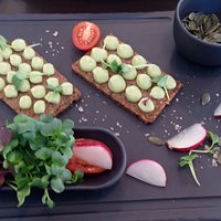 Rye bread with avocado mousse, mix of sprouts and pumpkin seeds.