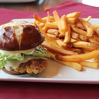 Our Popular Schnitzel sandwich served on a pretzel bun accompanied with french fries.