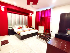 Hotel Unistar in New Delhi, image may contain: Screen, Ceiling Fan, Monitor, Bedroom