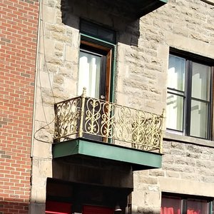Red doors. Left goes up stairs to upper flats. Right door to ground floor flat.