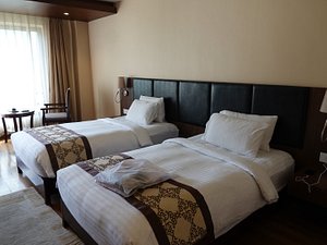 Ariya Hotel in Thimphu, image may contain: Chair, Furniture, Bed, Bedroom