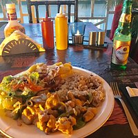 Curried chicken, rice and peas, salad with Ting