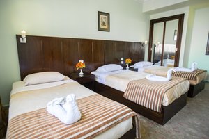 Swiss Inn Hotel in Cairo, image may contain: Bed, Furniture, Hotel, Bedroom