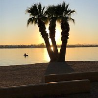 the sun sinks behind the horizon