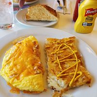 Ham and cheese omlet with hash browns and toast.
