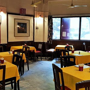 Broadway Hotel in Kolkata (Calcutta), image may contain: Restaurant, Cafe, Indoors, Chair