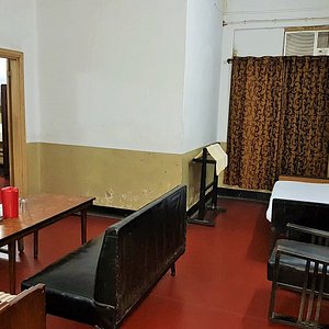 Broadway Hotel in Kolkata (Calcutta), image may contain: Restaurant, Cafe, Indoors, Chair