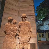 In Rocks Square, The Rocks, a three-sided sculpture entitled "First Impressions" by Bud Dumas. This side is called "The Settlers"; the other sides are called "The Soldier" and "The Convict." (AlpinerHut)