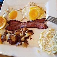 Classic egg breakfast with bacon, breakfast taters, and english muffin.
