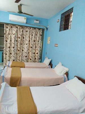 Pari Lodge in Chidambaram, image may contain: Hostel, Housing, Bed, Ceiling Fan